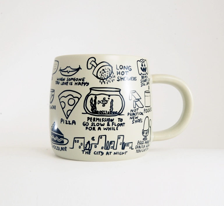 Cream ceramic mug with illustrated quotes and icons around the sides