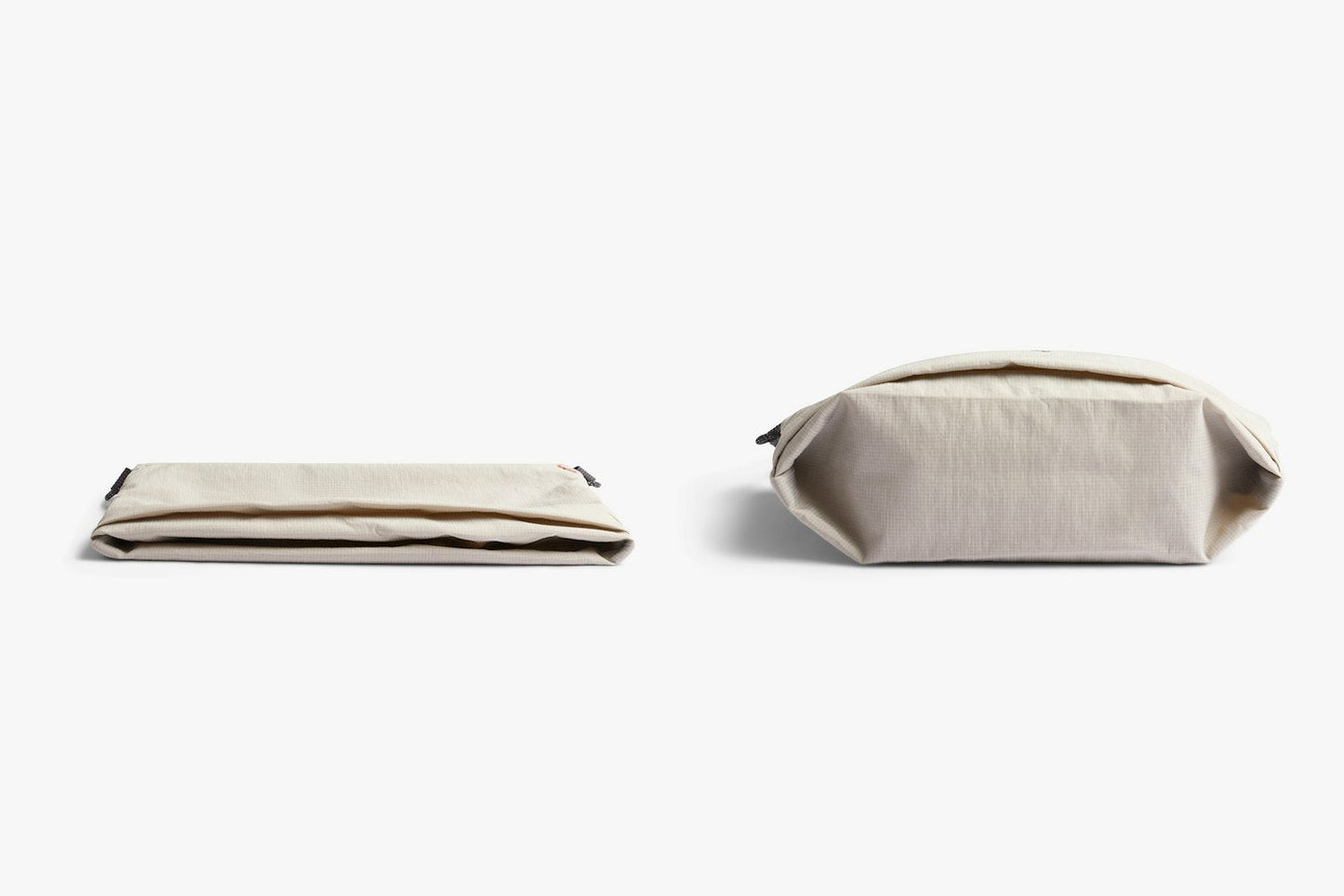 Light ash crossbody bag shown folded with zip closure, top view