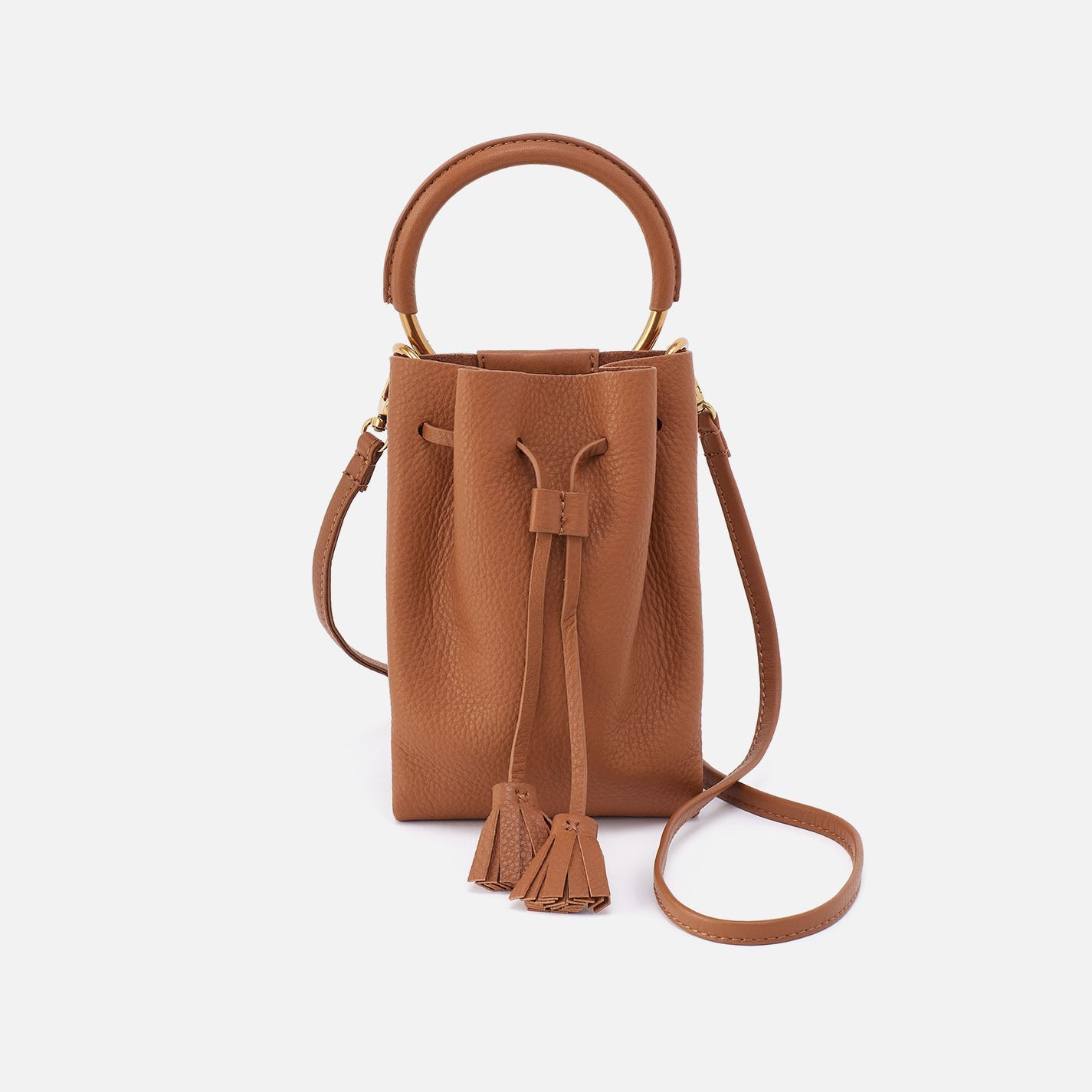 Warm honey phone crossbody bag with top handle, tassel pull and magnetic front pocket.