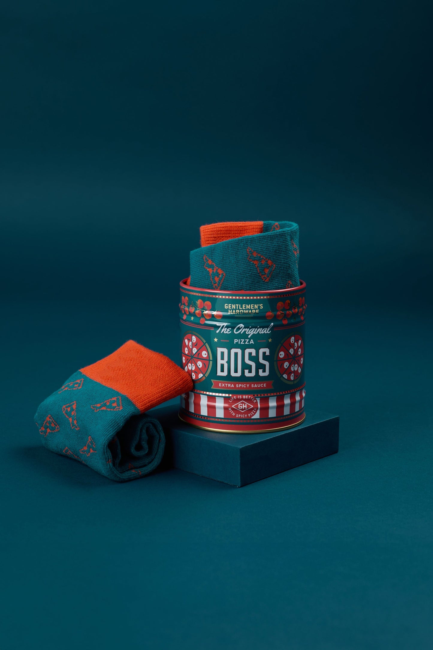 Teal rolled crew socks with pizza slice patterns in branded can.