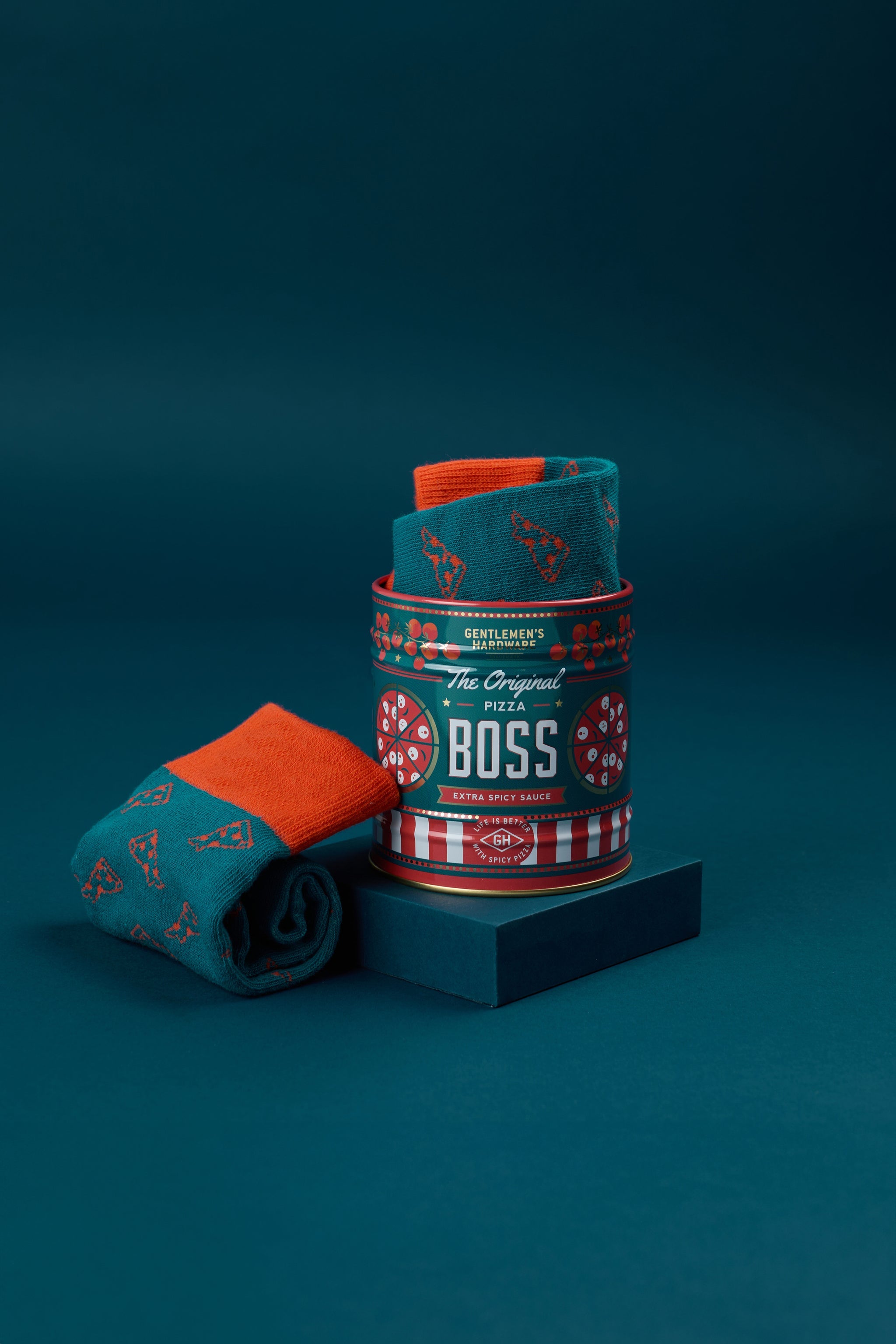 Teal rolled crew socks with pizza slice patterns in branded can.