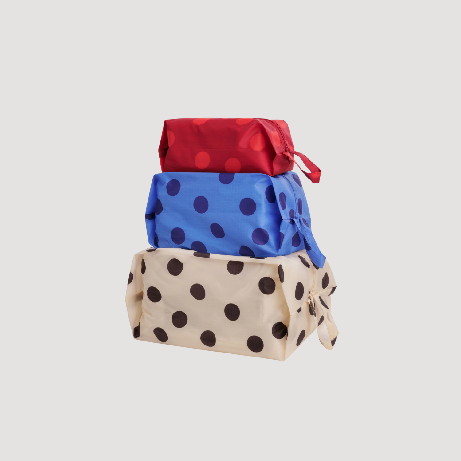 3D zip set with blue dot print, red top, and tan pouch