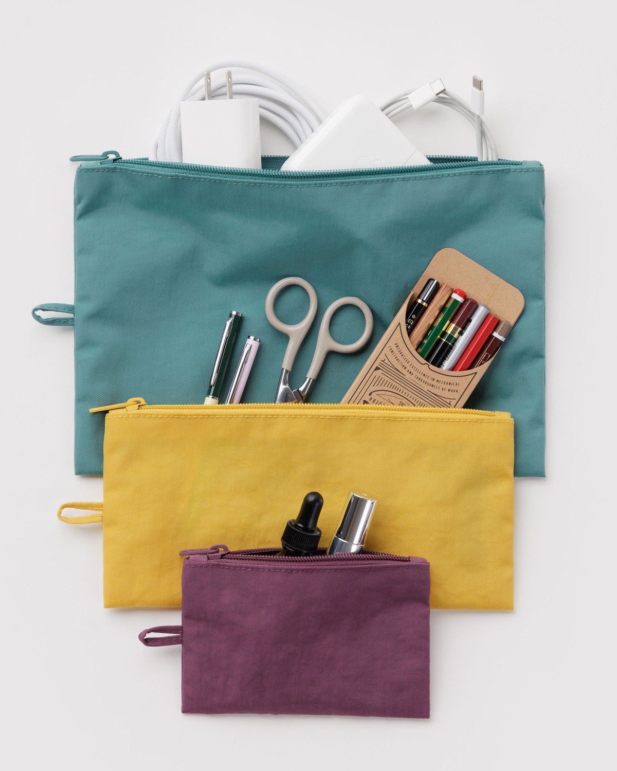 Set of three flat zip pouches: teal, mustard yellow, and plum colors