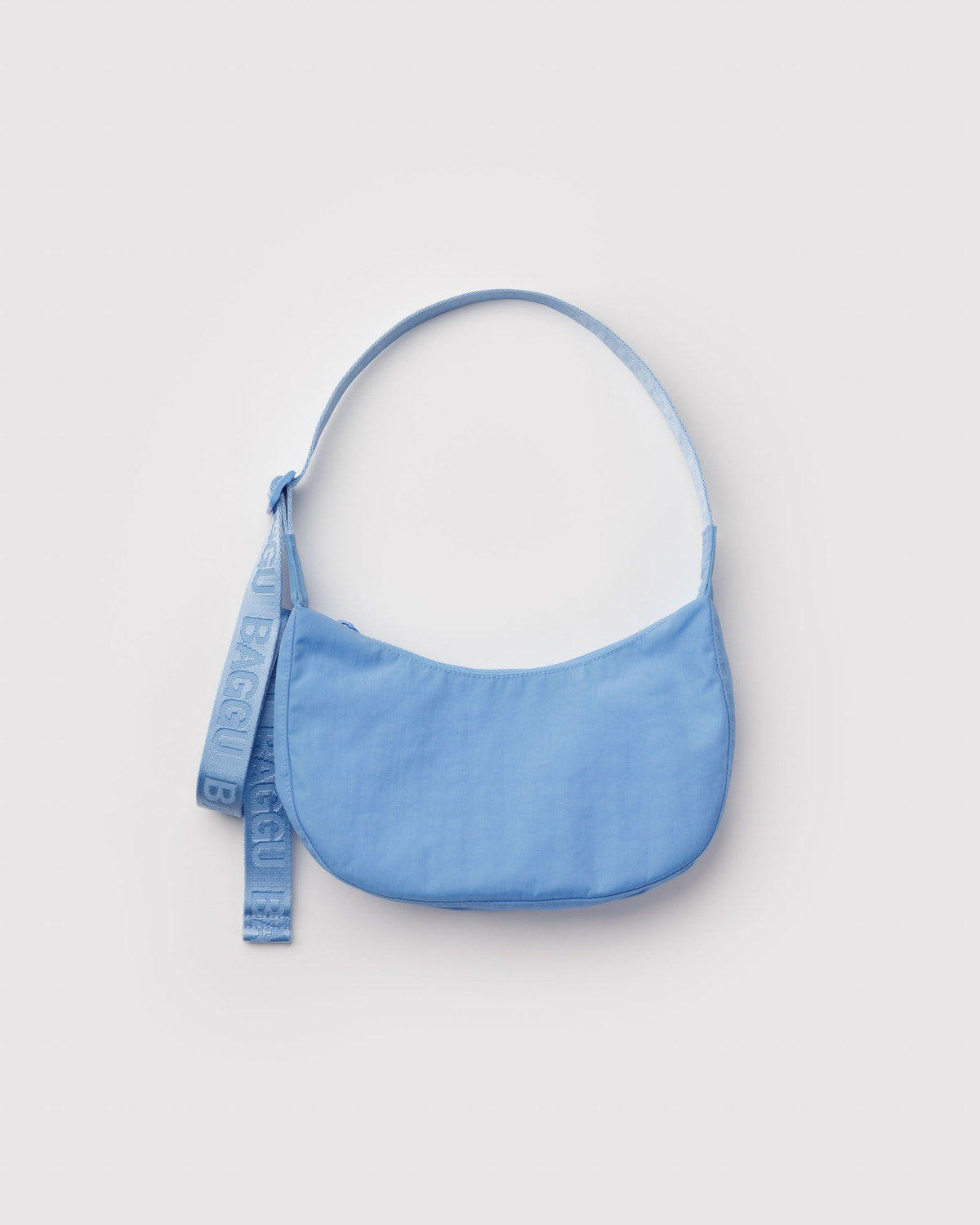 Small nylon crescent bag in light blue with long webbing strap and brand tag