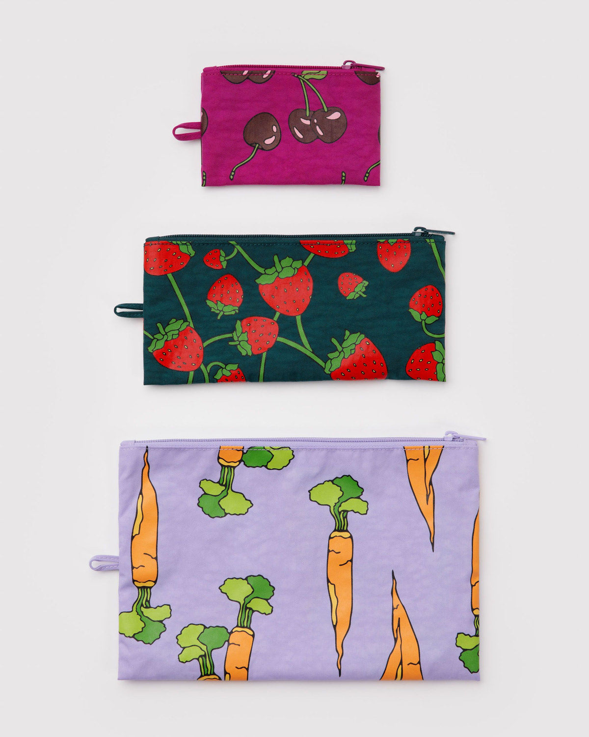 Set of three flat zipper pouches with cherry, strawberry, and carrot prints in purple and green