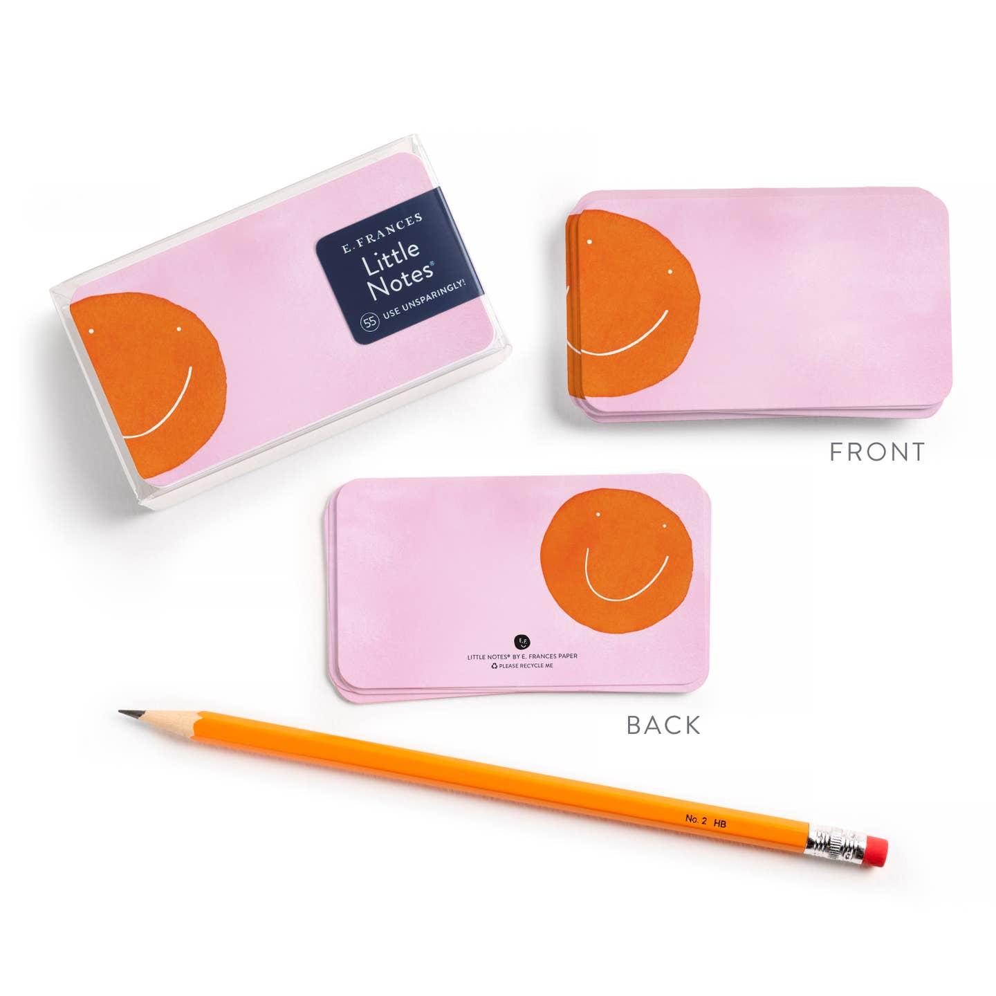 Pink sticky note pad set with orange smiley; clear cover and pencil visible
