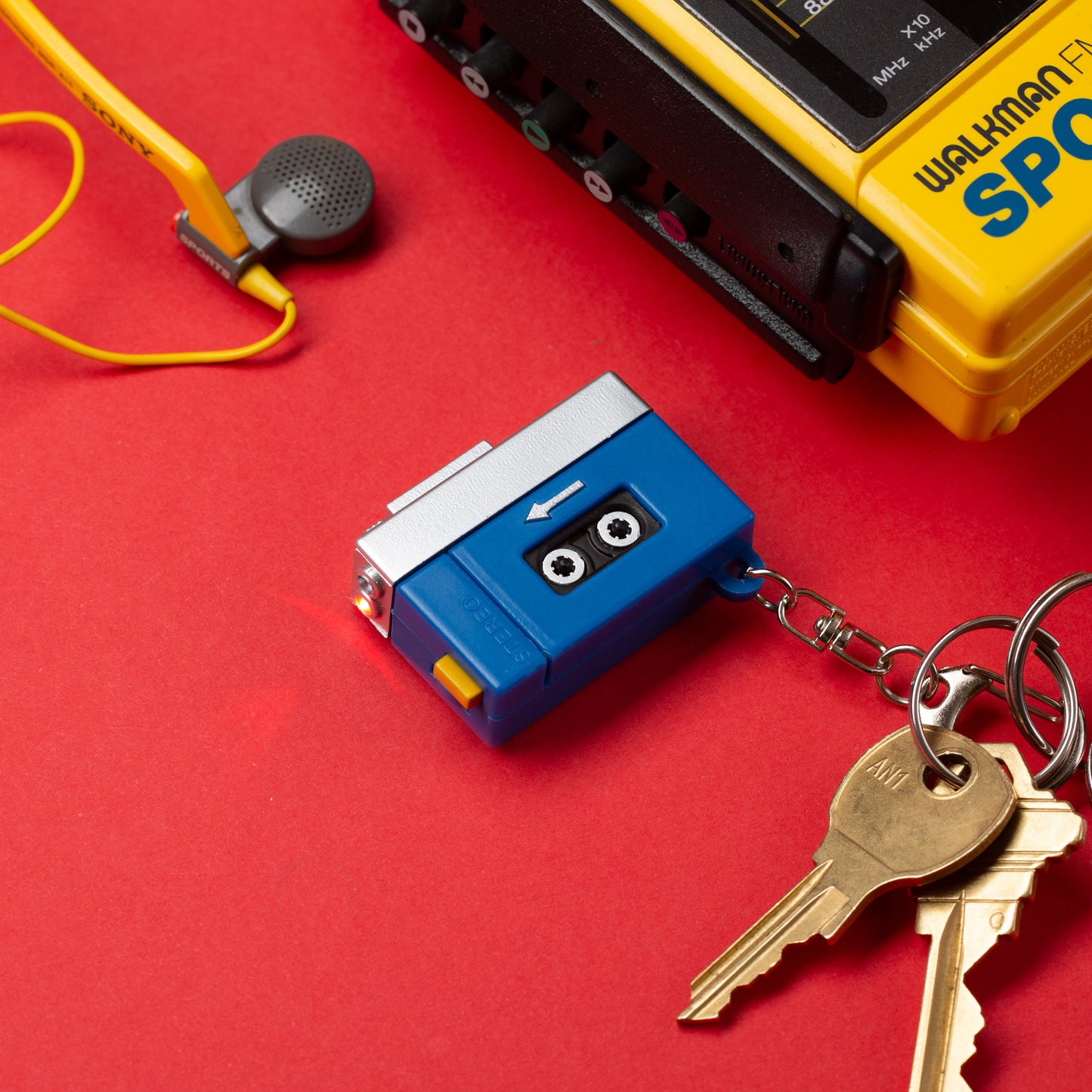 Cassette-style tape player LED keychain with attached keys on metal ring