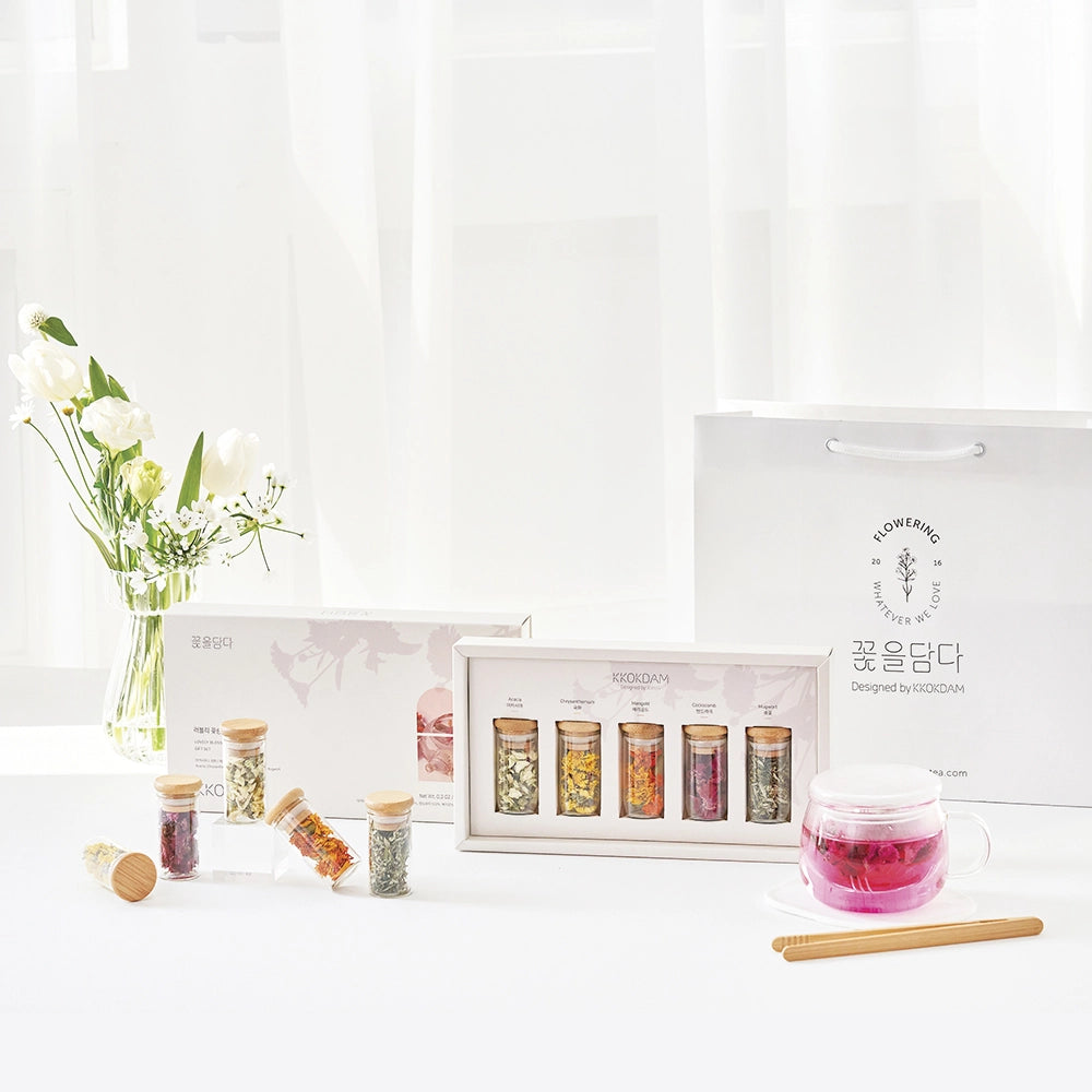 Flower tea gift set with pink glass tea cup, wooden stirrer, and boxed jar assortment