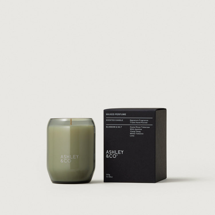 Waxed perfume candle in smoky olive glass jar with black scent box