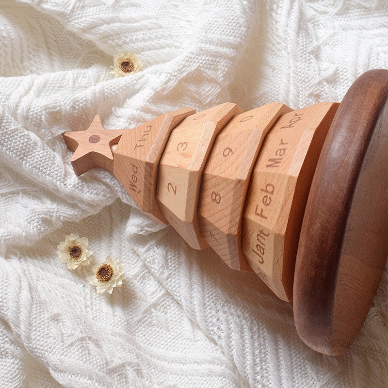 Wooden Christmas tree calendar close-up of carved day blocks and star top