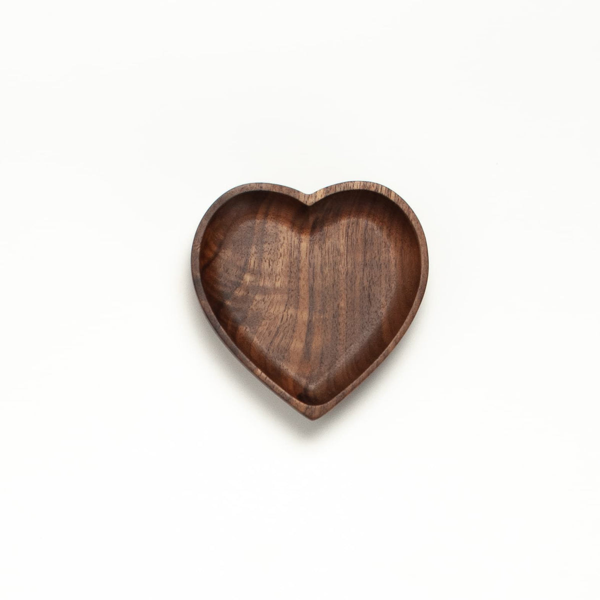 Walnut wood heart tray with smooth curved edges and natural grain