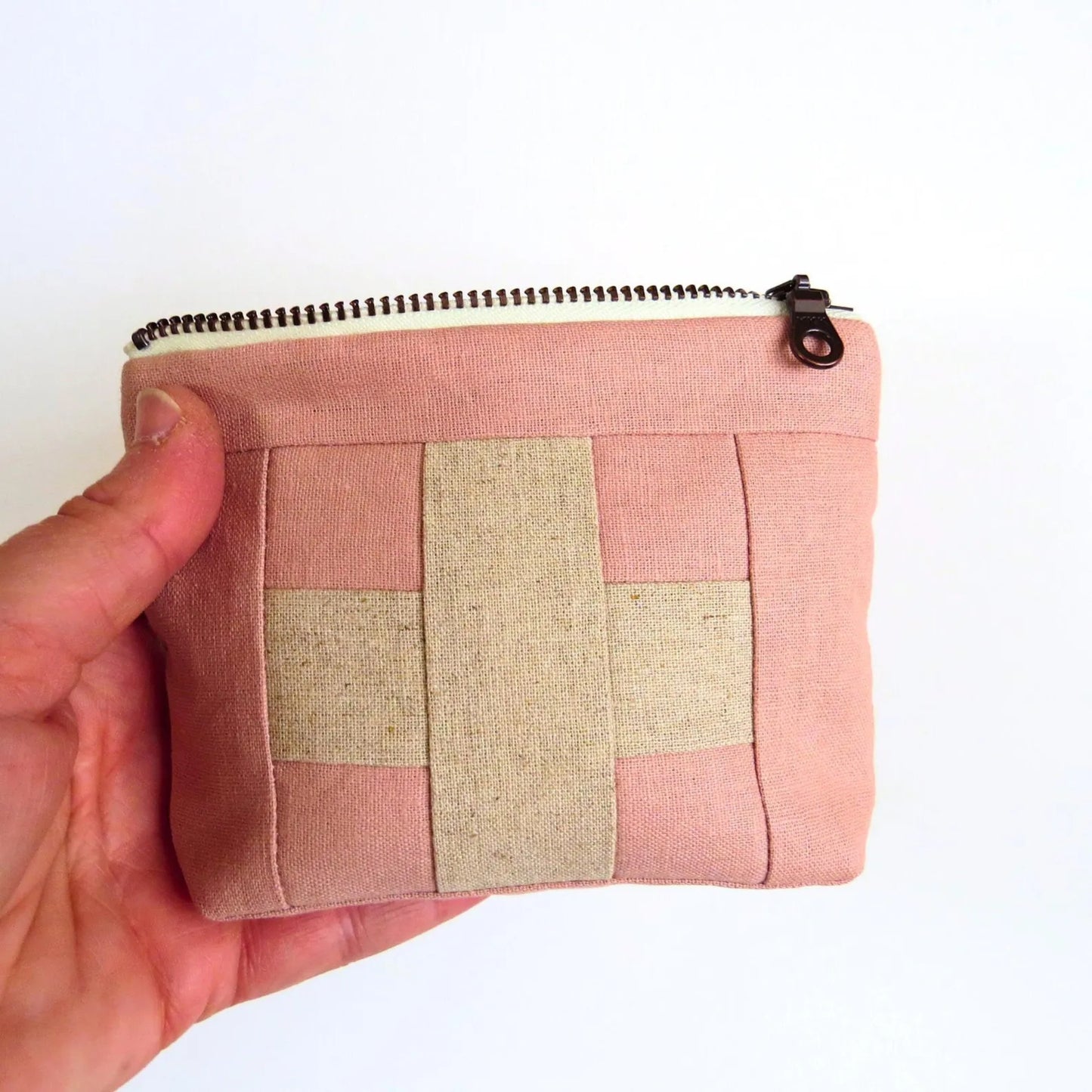 Mini first aid kit pouch in light pink fabric with cream patchwork cross and top zipper
