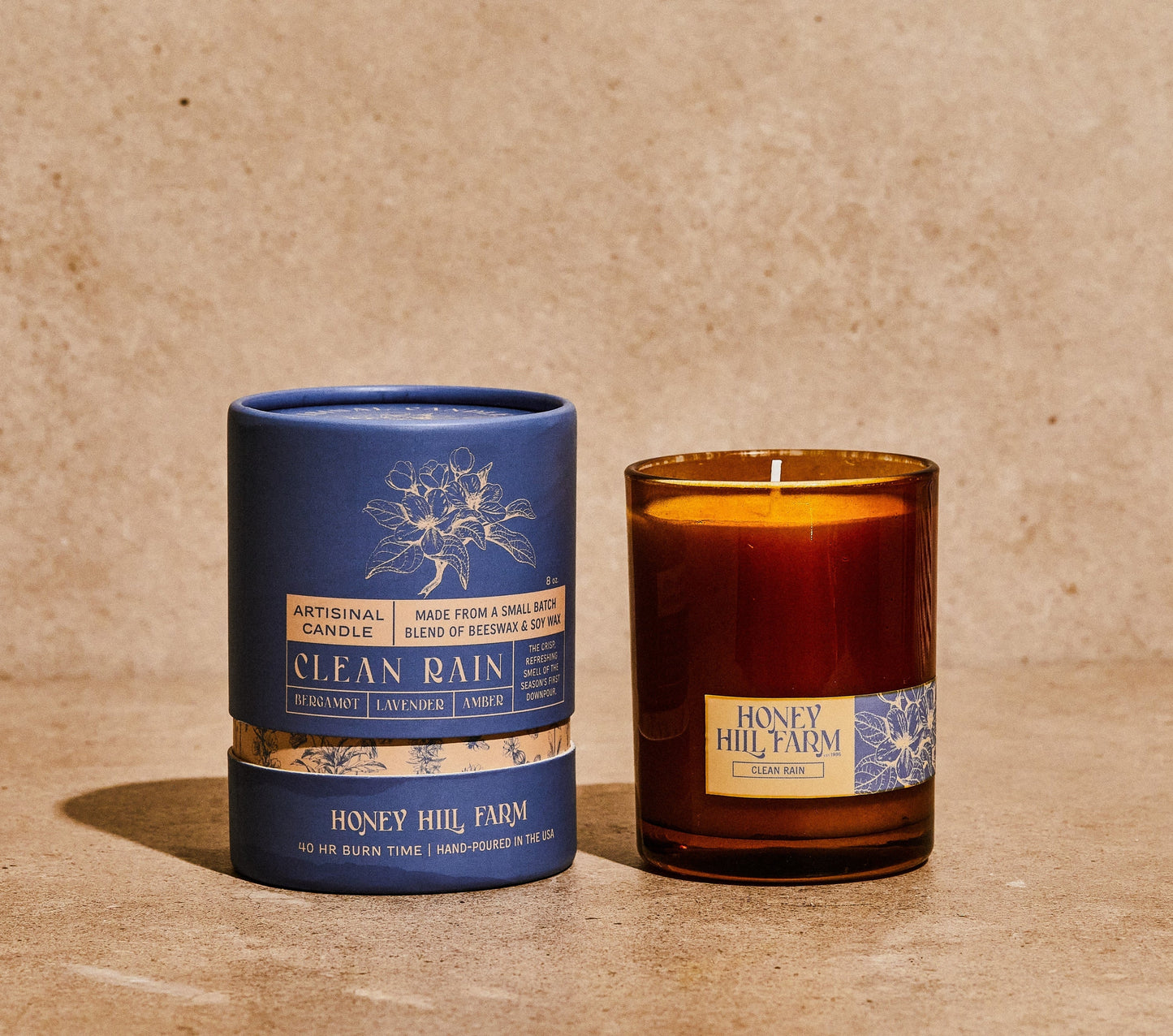 Blue and amber glass candles with Honey Hill Farm labels and cotton wicks