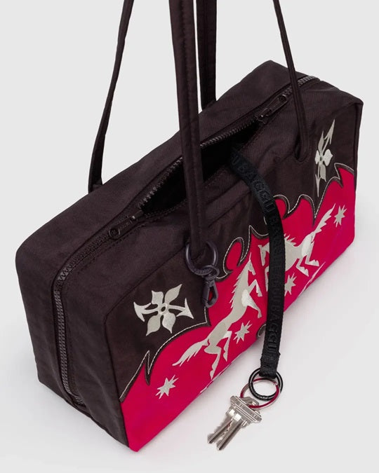 Nylon bowler bag with long zipper and red side panel; black fabric with white applique icons.