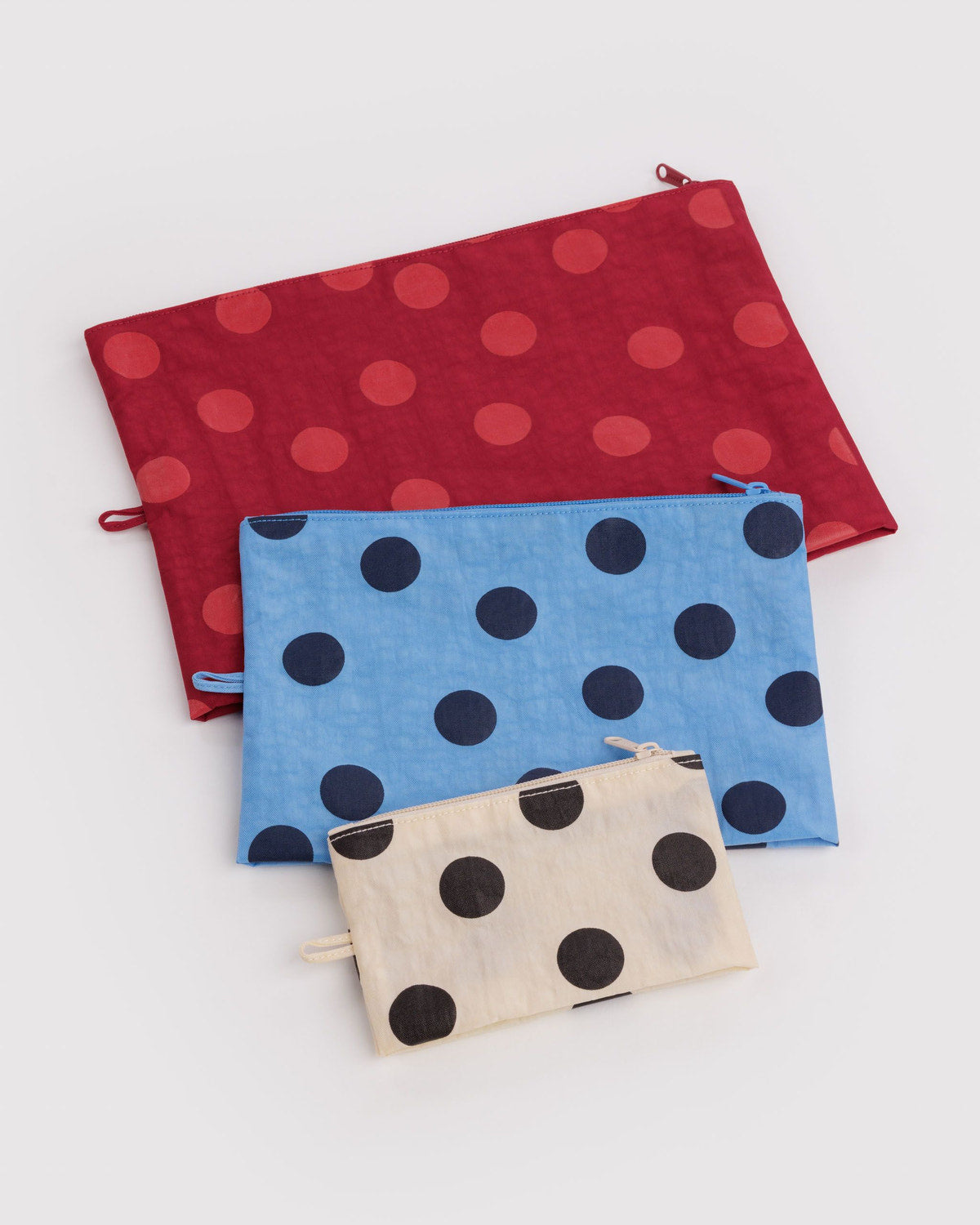 Go pouch set of three fabric zip pouches with red, light blue, and beige polka-dot prints