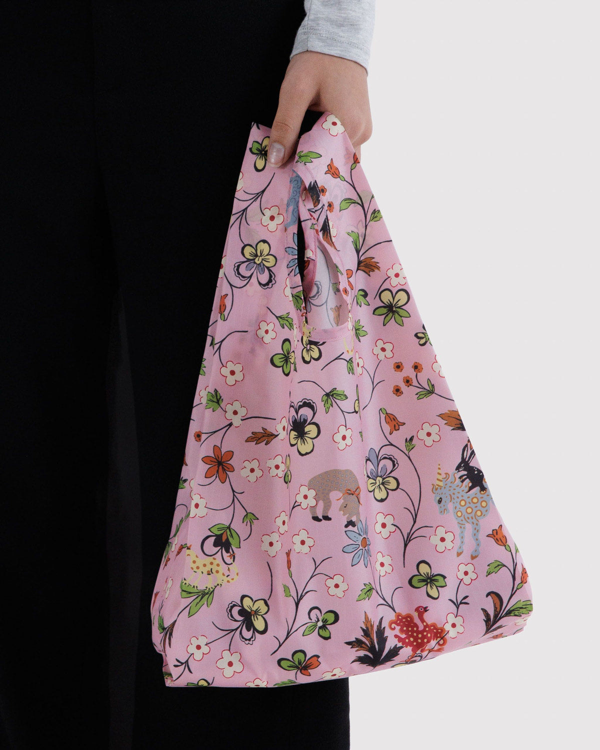 Reusable tote bag with pink floral garden print and curved top