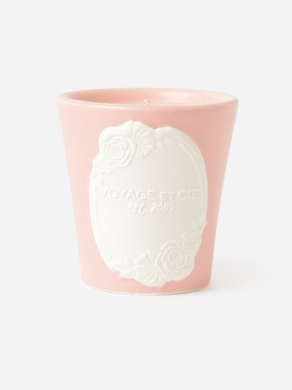 Cameo candle in pink tumbler with white cameo medallion relief