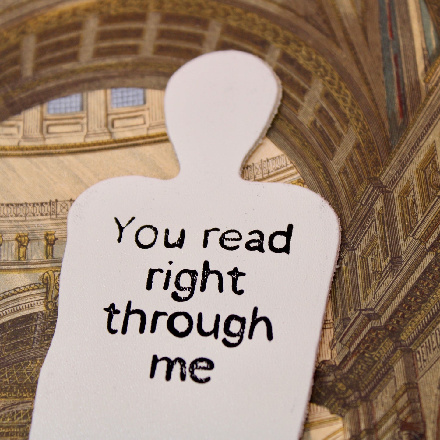 Cream leather bookmark shaped like a person with text: "You read right through me"