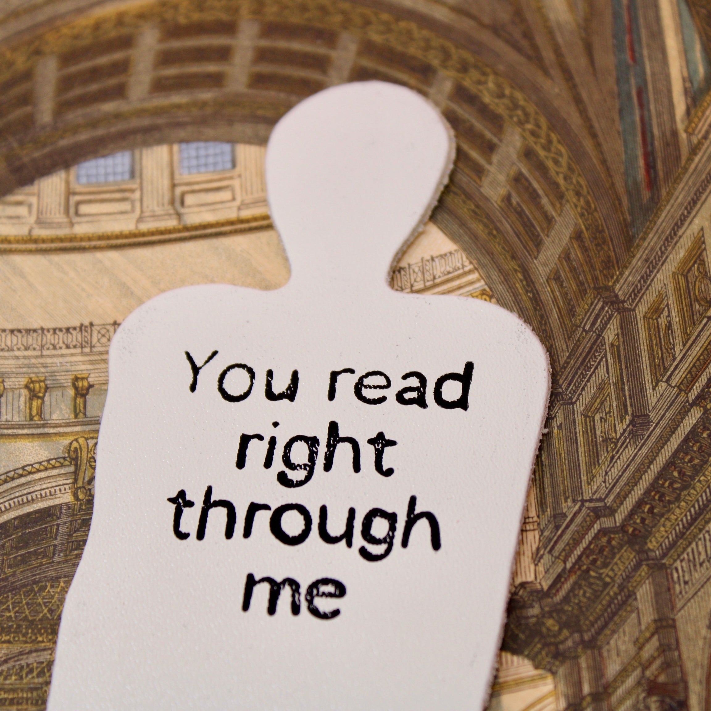 Cream leather bookmark shaped like a person with text: "You read right through me"