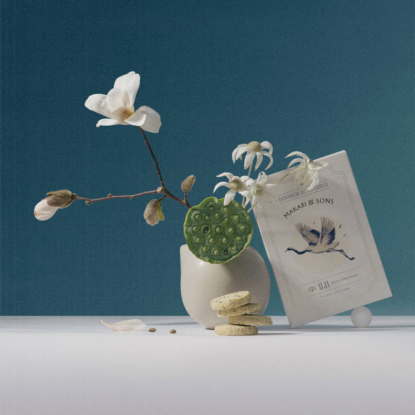 Matcha black sesame cookies with branded cookie pouch and scattered pieces