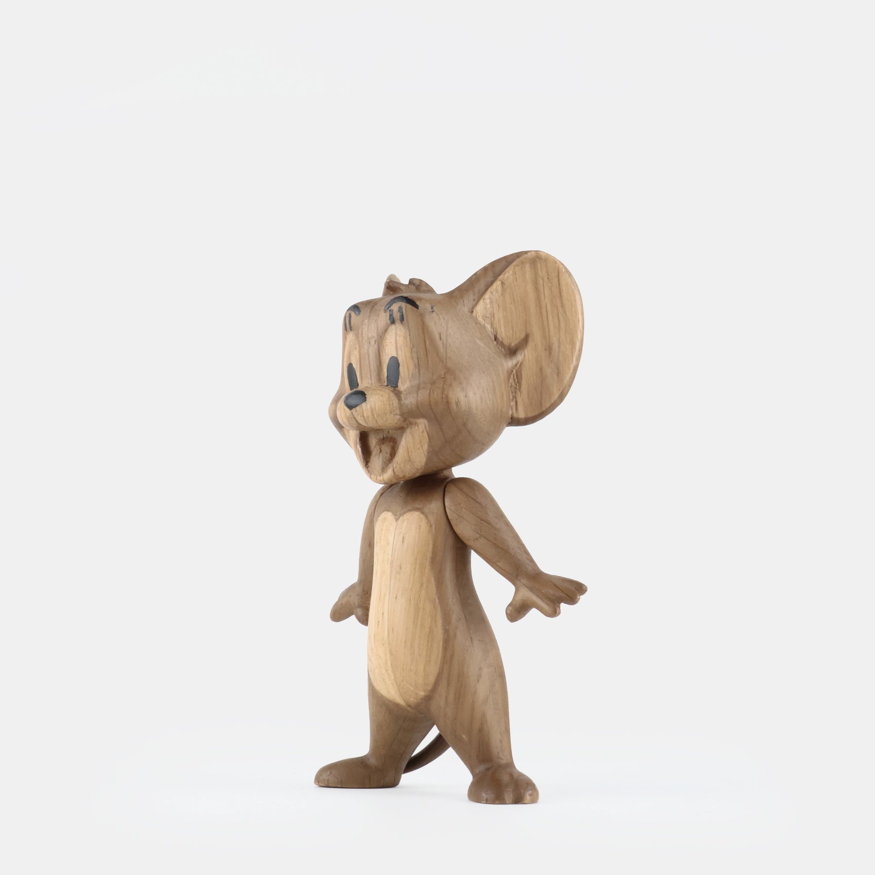 Small smoked oak figurine, side view with large ears and carved wooden tail