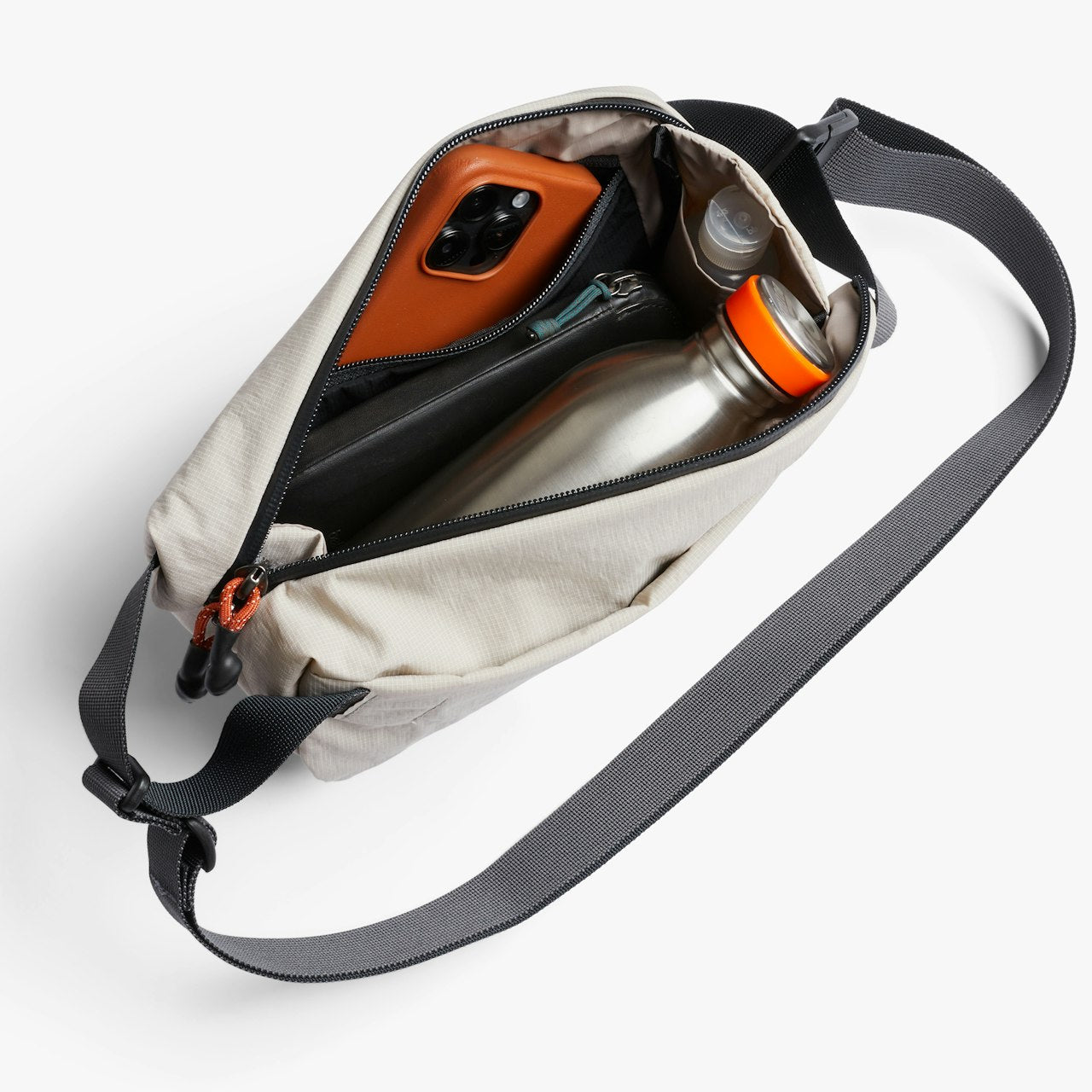Off-white mini sling bag opened, showing phone, stainless bottle, and drink container.