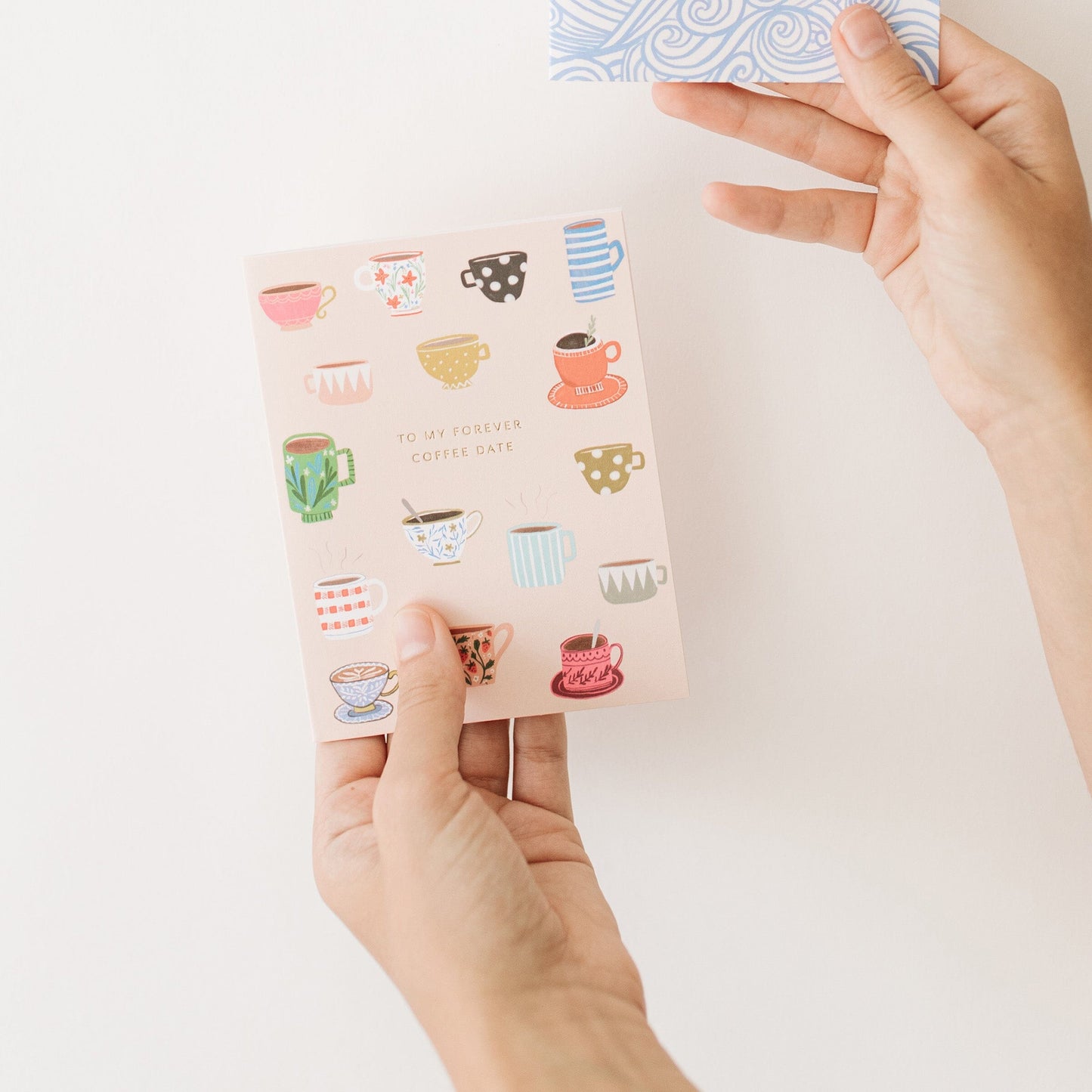 Coffee date card held by hands; colorful coffee cup pattern and “To my forever coffee date”