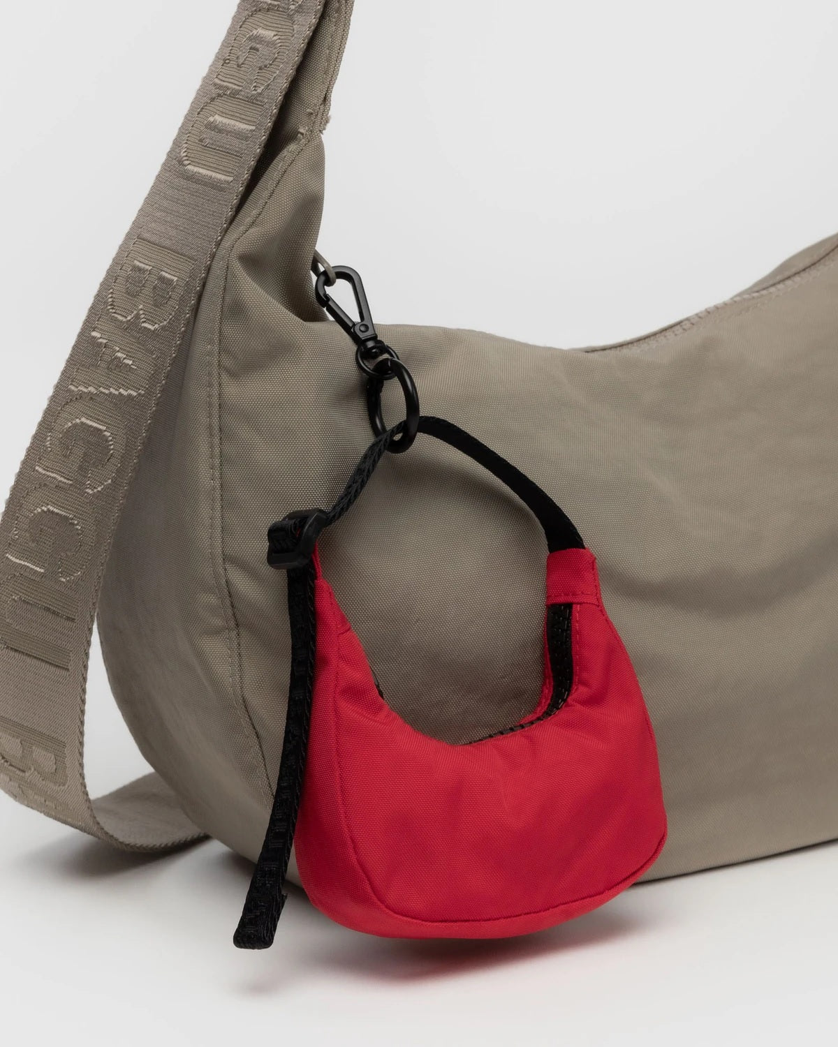 Red crescent bag charm pouch with black loop and clip