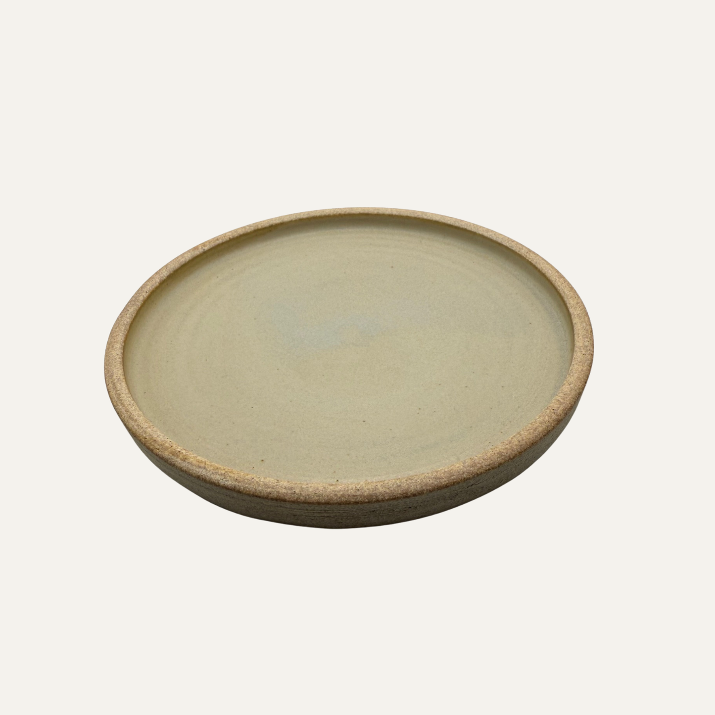 Cream matte glazed 8-inch plate with rounded rim and speckled glaze edge