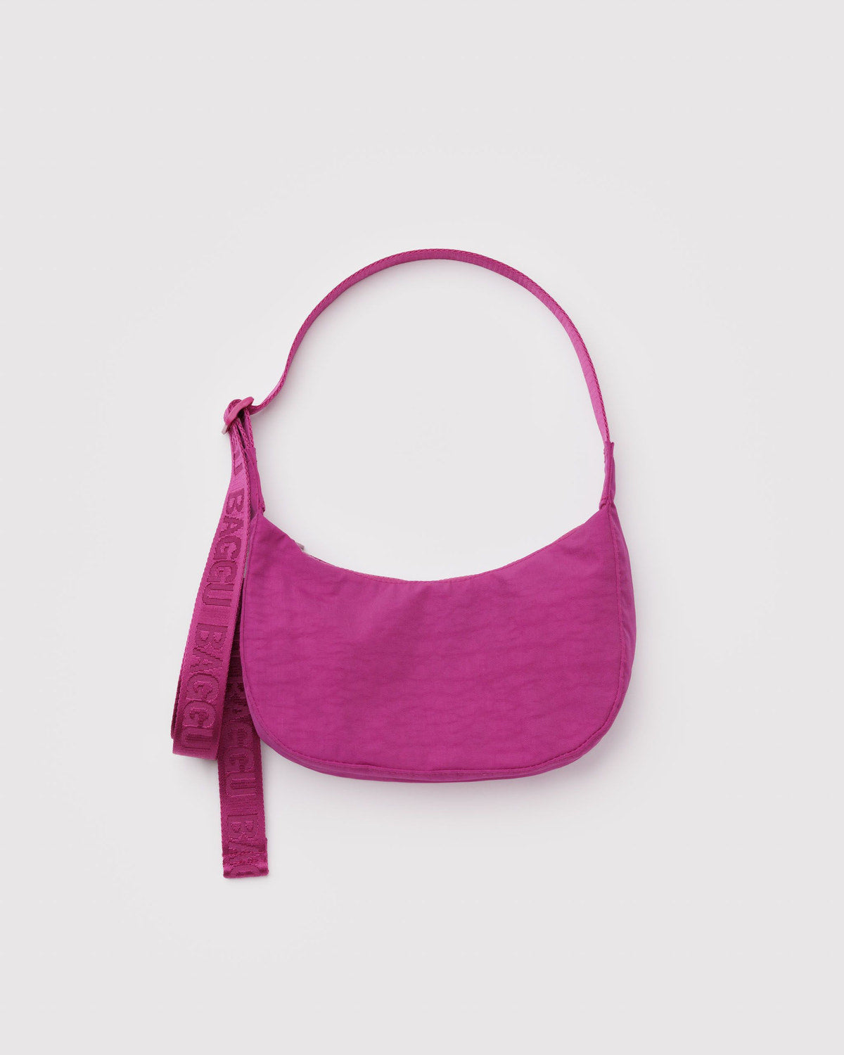 Small nylon crescent bag in bright magenta with matching adjustable shoulder strap