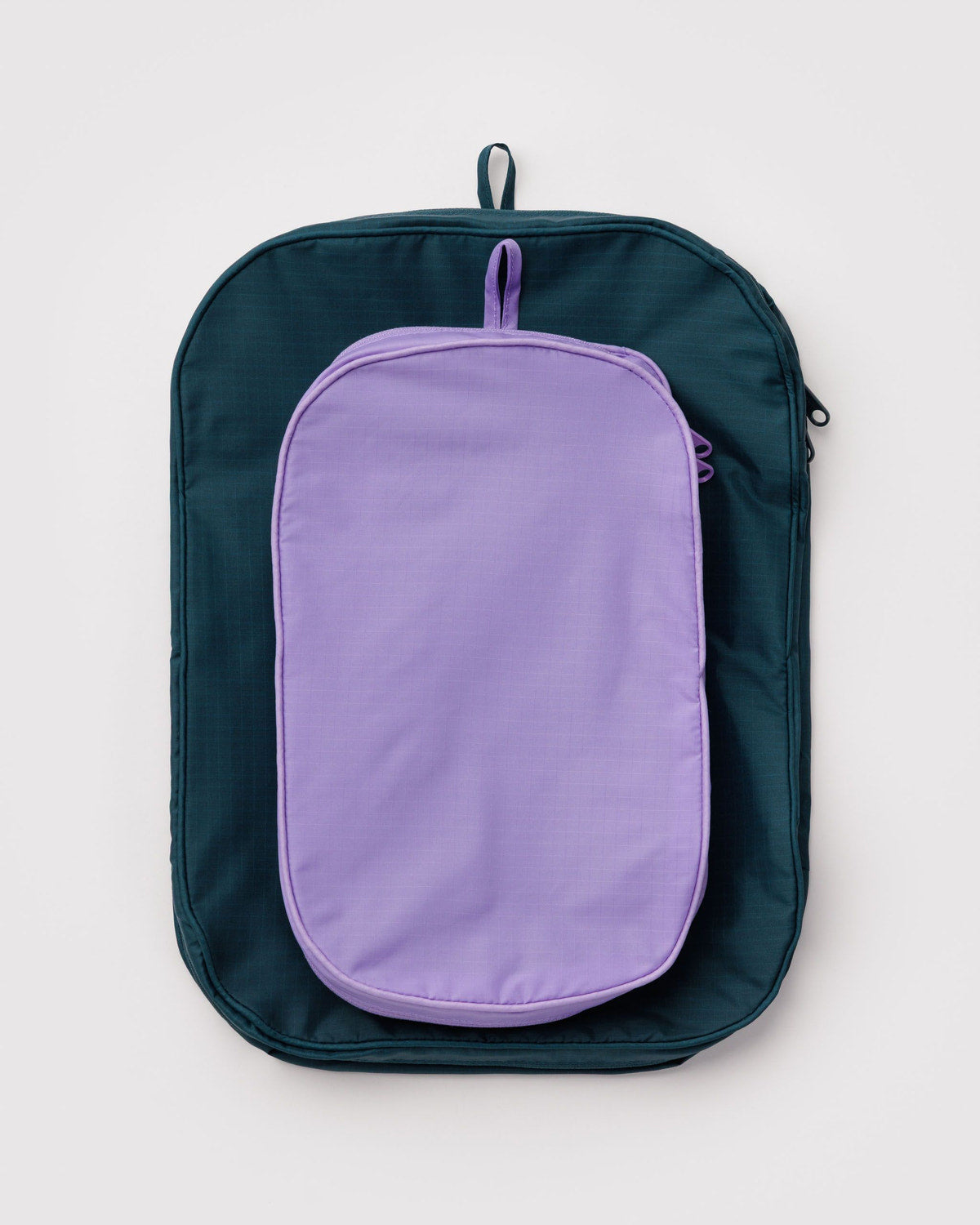 Packing cube set in dark teal with purple inner panel and hanging zip pull