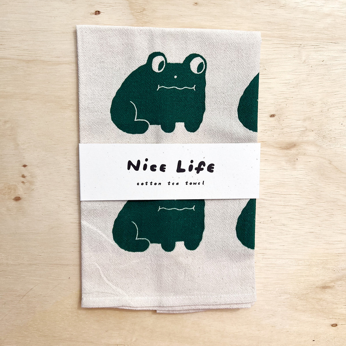 Frog tea towel with green frog graphic and 'Nice Life' text label