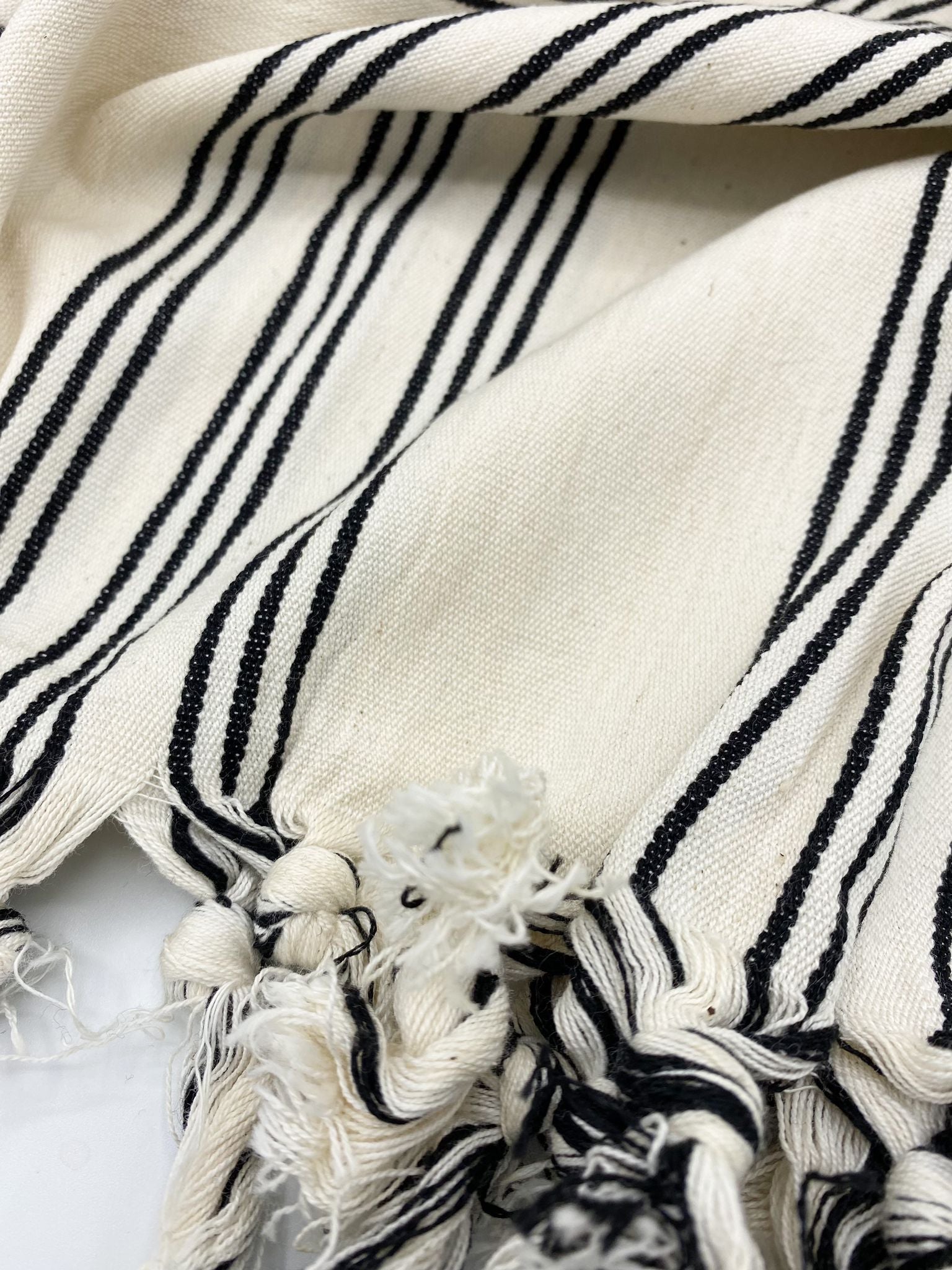 Cream Turkish cotton towel/throw with bold black vertical stripes and tassel fringe