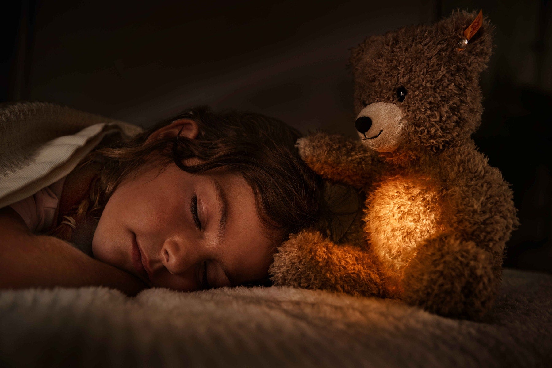 Light at Night Caspar teddy bear with warm light glow, tan plush, black button nose