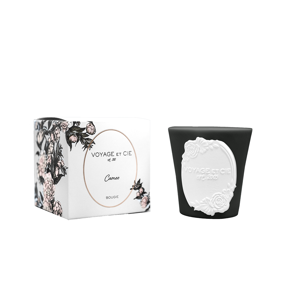 Cameo candle in dark tumbler with white cameo medallion relief
