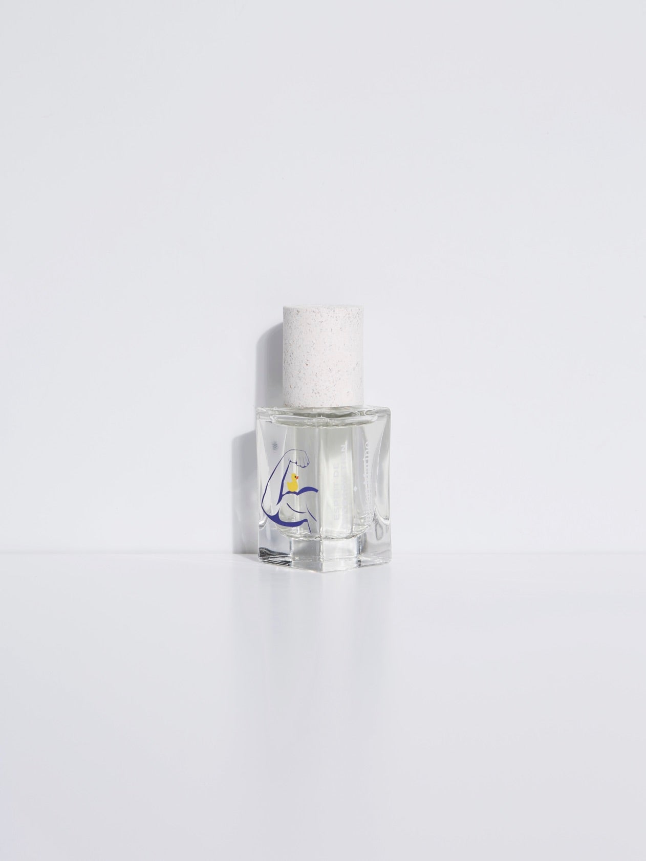 Clear eau de parfum bottle with white textured cap and blue logo on front