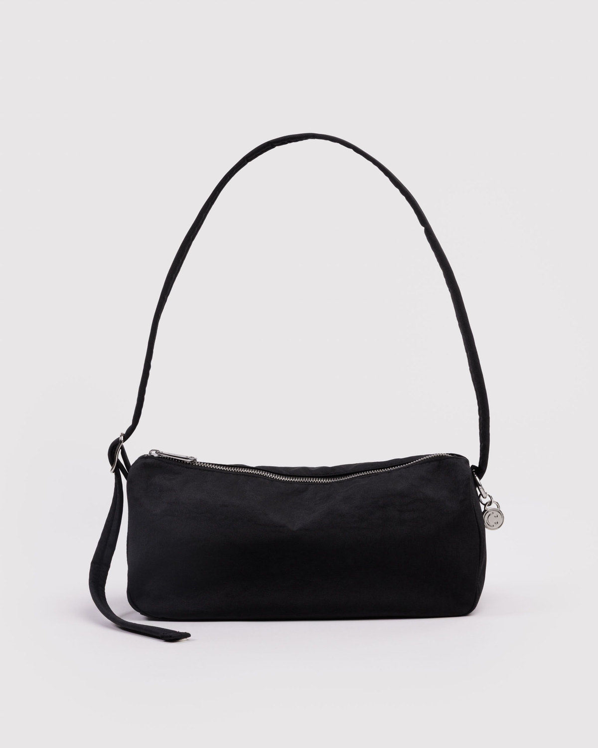 Black nylon loaf bag with curved top handle, side strap, and top zipper.