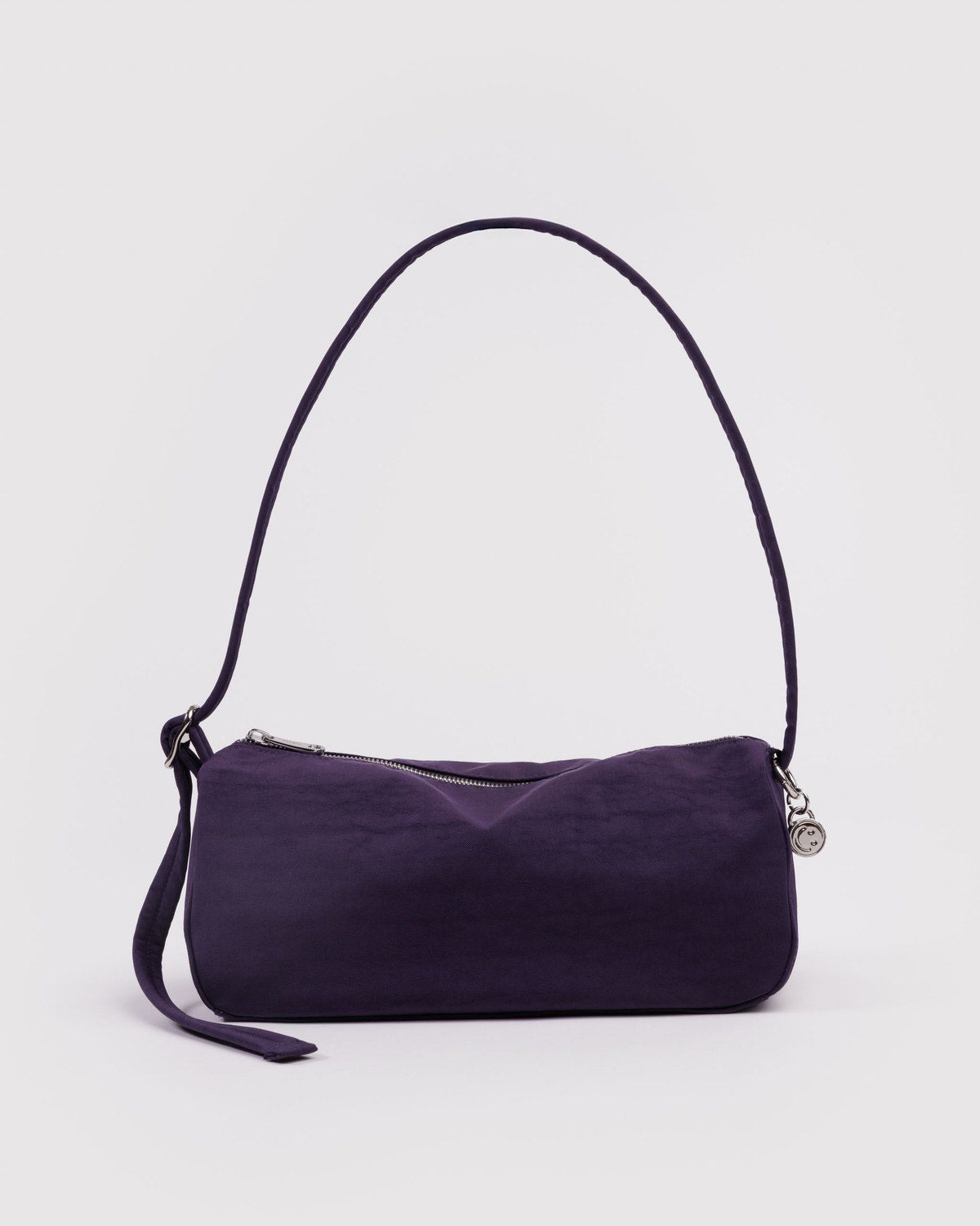 Fig nylon loaf bag with curved top handle, side strap, and top zipper.