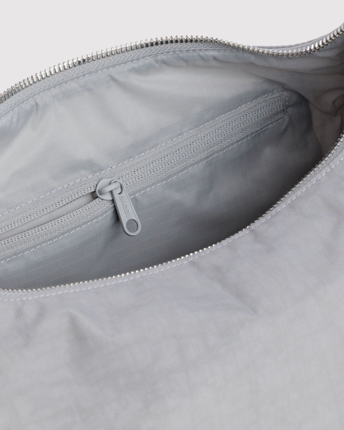Light gray nylon bag interior with zipper and zippered pocket