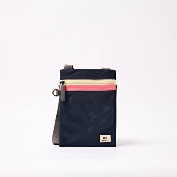 Navy recycled nylon pocket crossbody bag with top zipper and red accent stripe