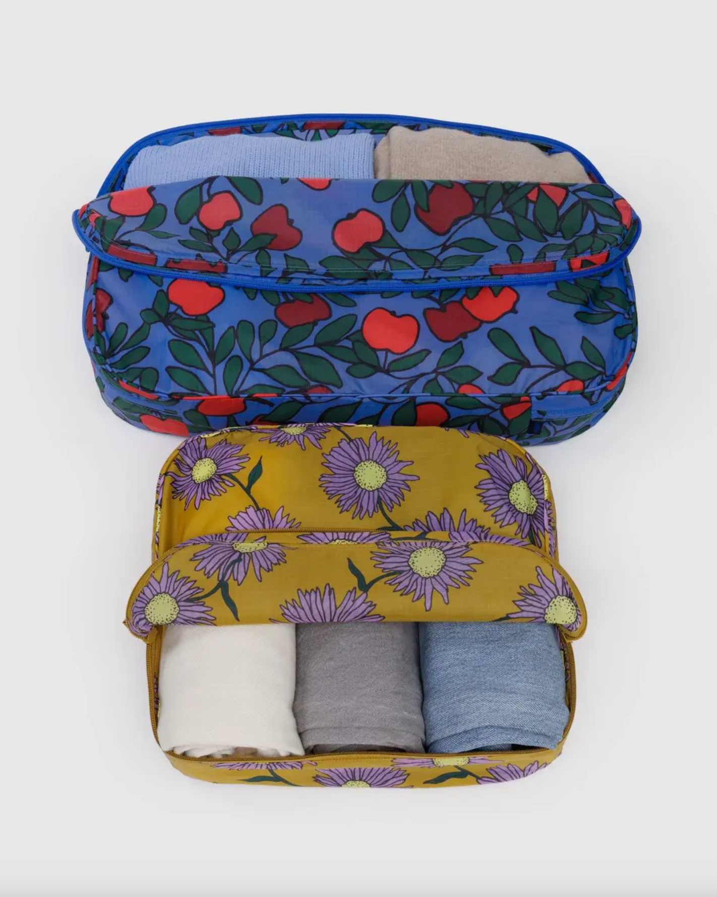 Large packing cube set with blue-green leaf print and yellow daisy interior view