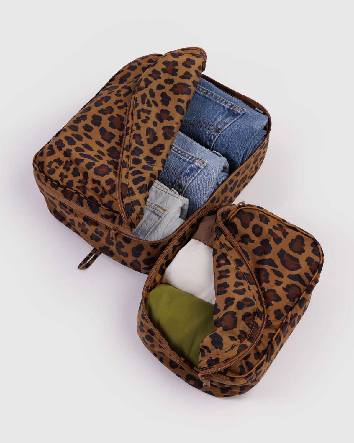 Packing cube set in leopard print, one cube open showing olive-green interior