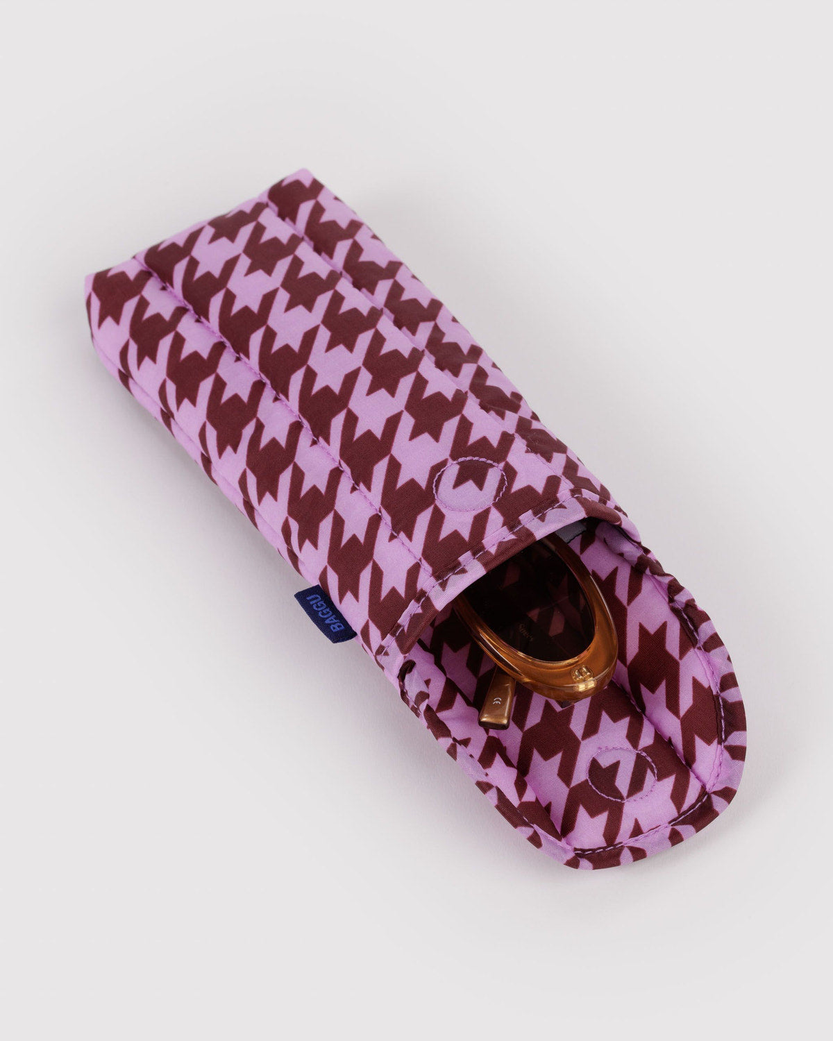 Puffy glasses sleeve in purple with white geometric pattern and zippered top opening