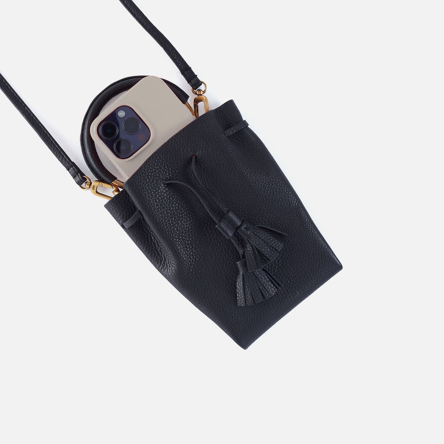 Black textured phone crossbody bag with phone insert slot and tassel detail.