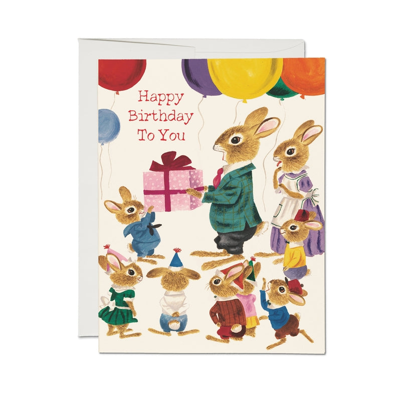 Birthday card with rabbit characters, balloons, and gift illustration
