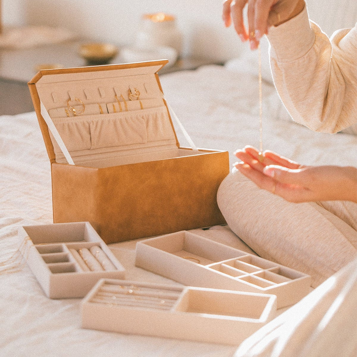 Open honey vegan leather jewelry box with removable organizer trays for jewelry.