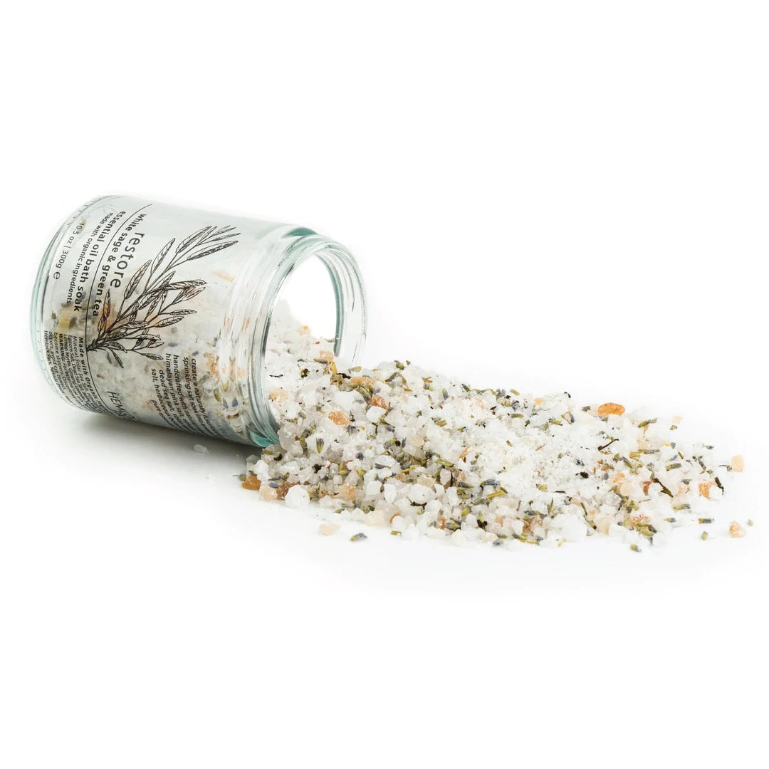 Bath soak crystals spilling from jar, showing white sage & green tea blend