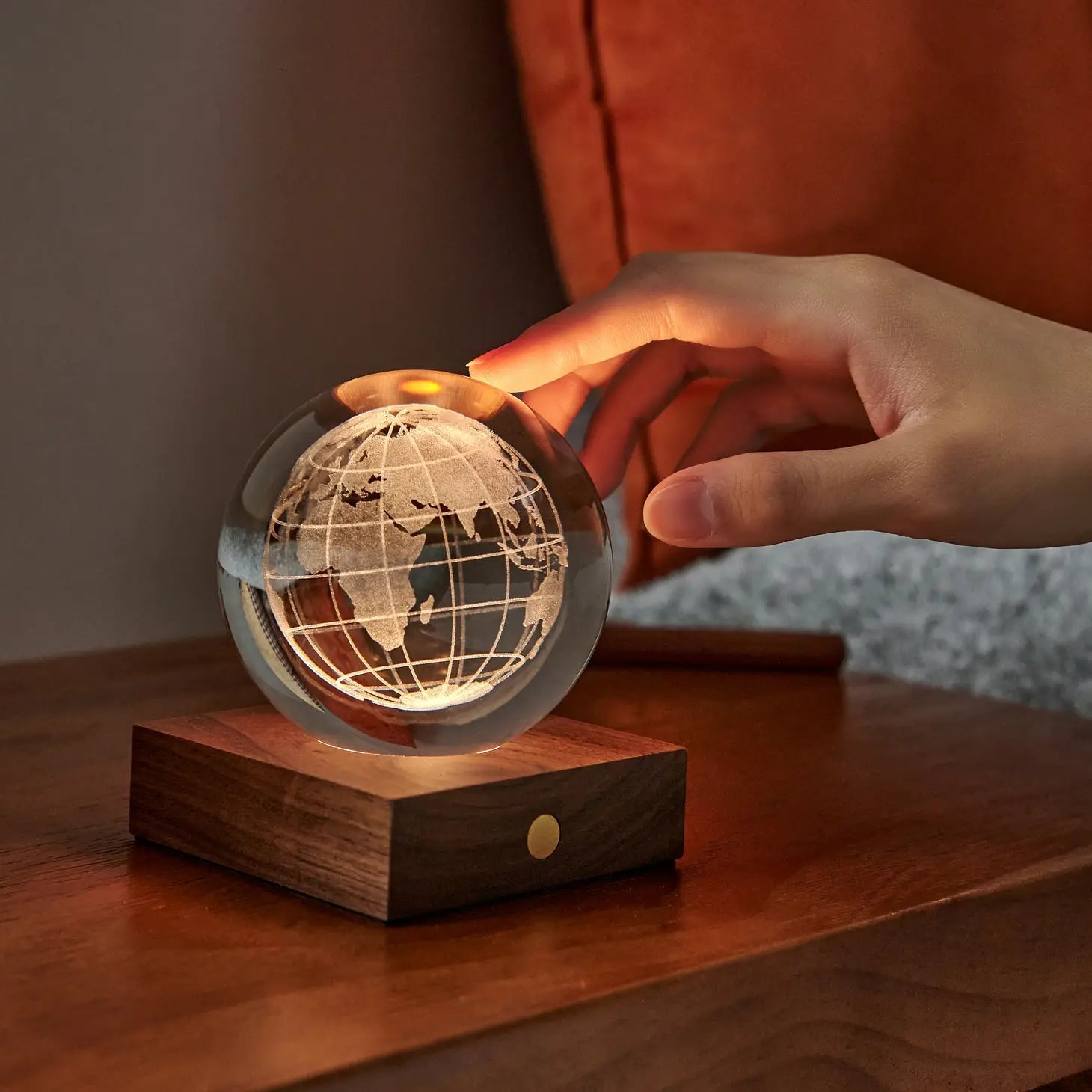 Globe crystal night light with amber lamp glow and wooden base