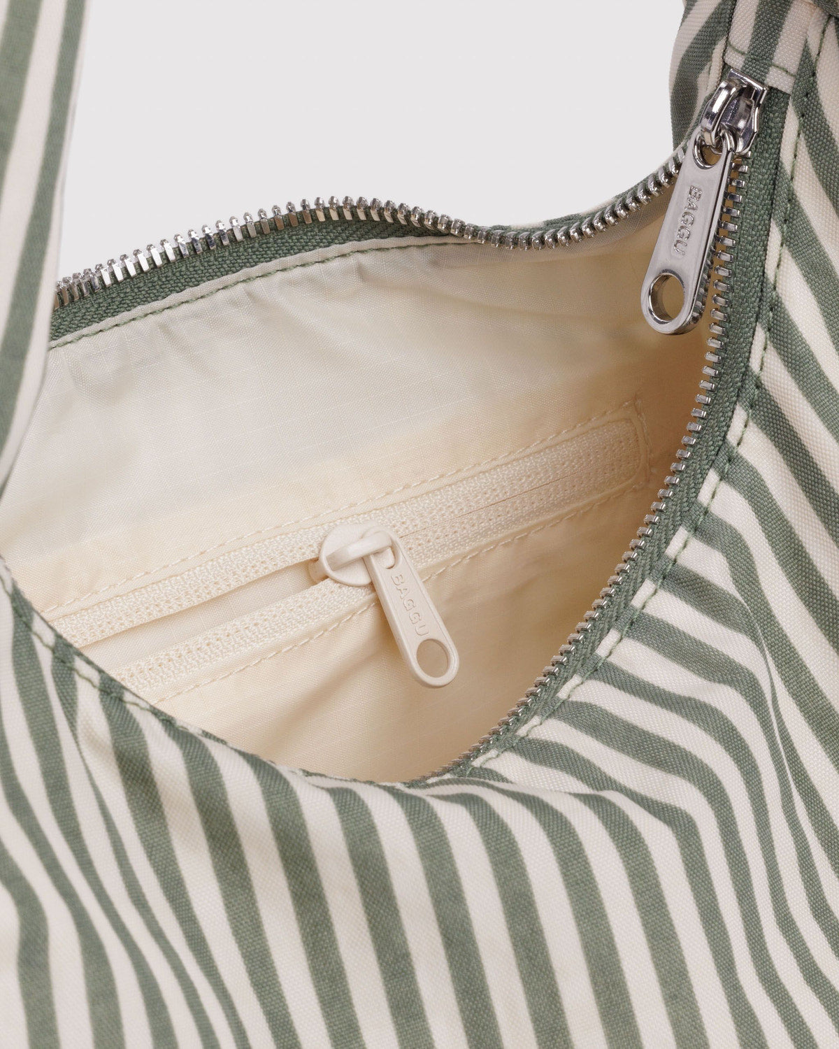 Small nylon bag interior with zipper closure and white drawcord tie