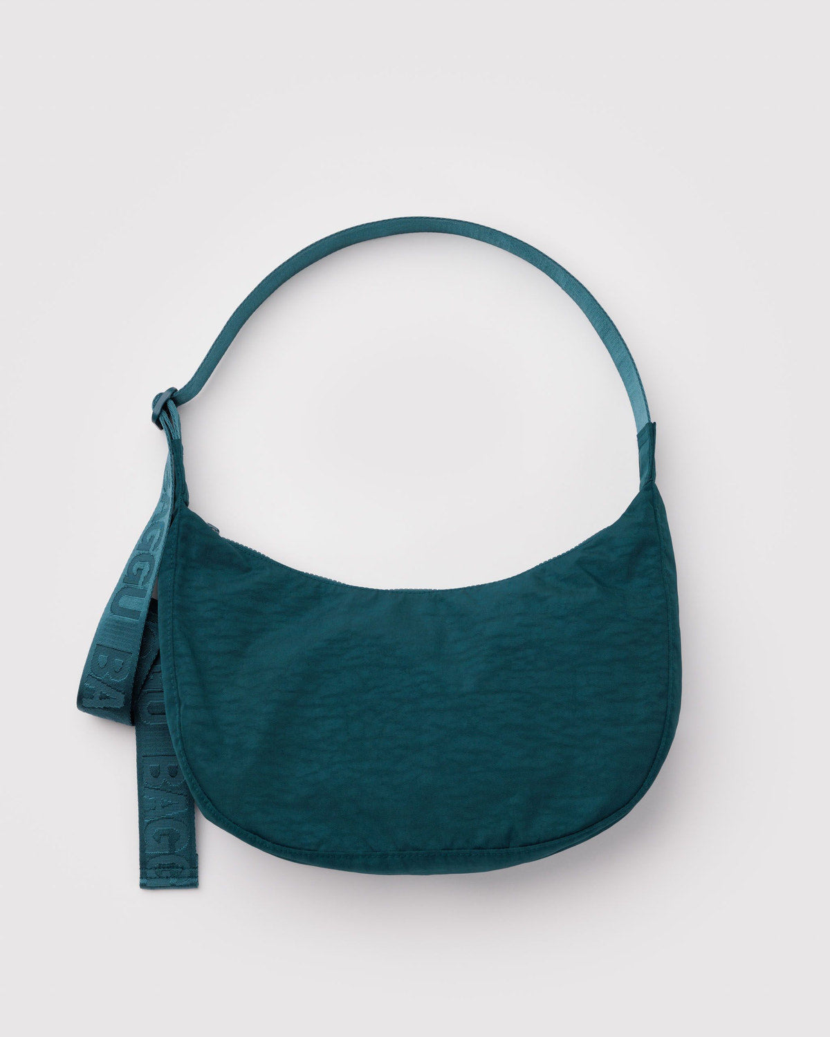 Teal nylon crescent bag with adjustable strap and small hanging tag